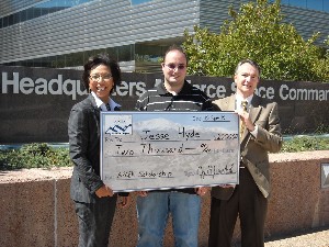 In October, Joyce Jenkins-Hardin (l), chapter vice president for education, and Rodney Pohlmann (r), chapter vice president, present Jesse Hyde, a University of Colorado sophomore, with an AFCEA General Emmett Paige Scholarship.